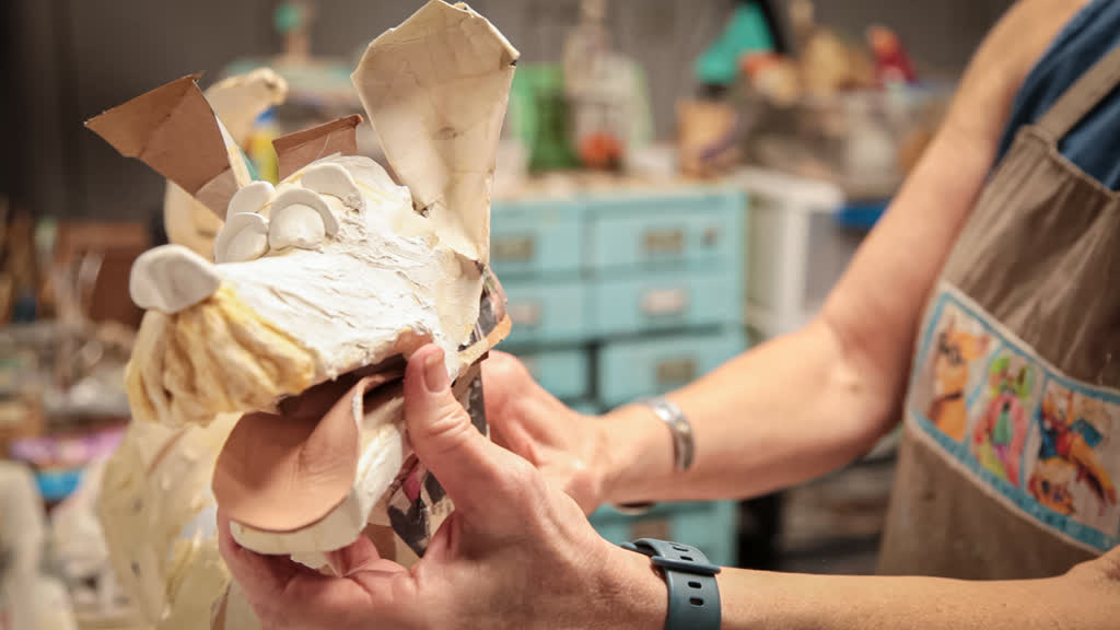 Joyce prepares the armature of a dog figure